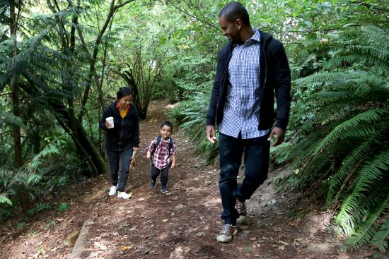 A family walks one of the trails at Mercer Slough