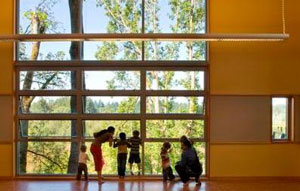 Families peer out at a window at the Mercer Slough Environme