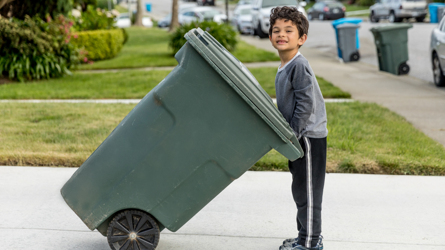 child with solid waste container