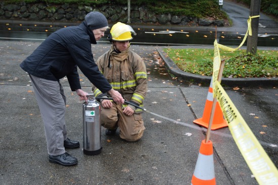 Image of Bellevue Fire Explorer assisting a resident with fi