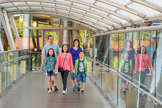 A family walks one of Bellevue's downtown skybridges.