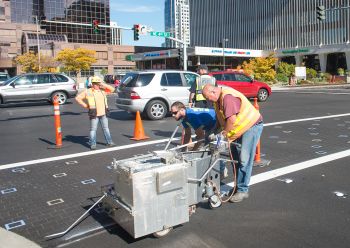 image of crew painting crosswalk at downtown intersection