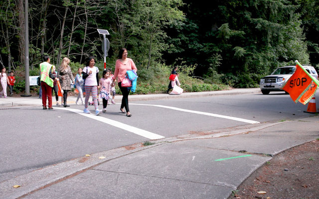 Students use a crosswalk improved via the Neighborhood Enhancement Program.