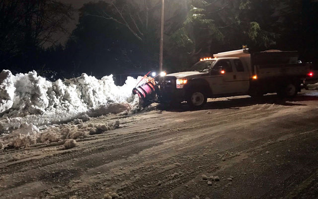 A plow clears the last of the snow on an arterial.
