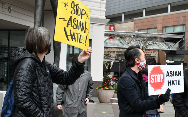 Bellevue residents protest hate crimes against Asian Americans at a rally downtown in March 2021.