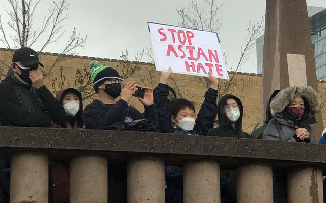 Hundreds gather at Downtown Park on March 27 to rally in support of Asian-Americans in the community.