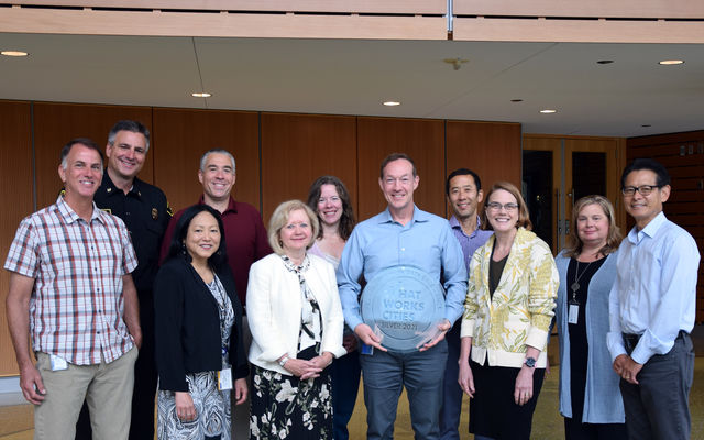 Bellevue's Leadership Team poses at City Hall with the What Works Cities plaque.