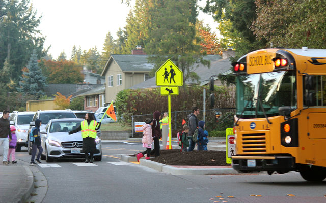 Students cross a street on their way to Newport Heights Elementary School.