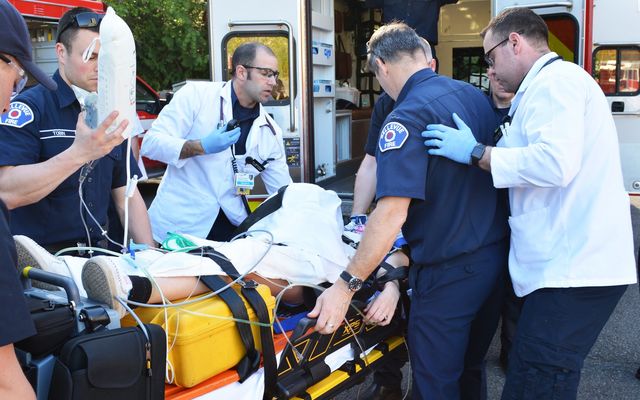 Bellevue paramedics treat a patient outside the ambulance.