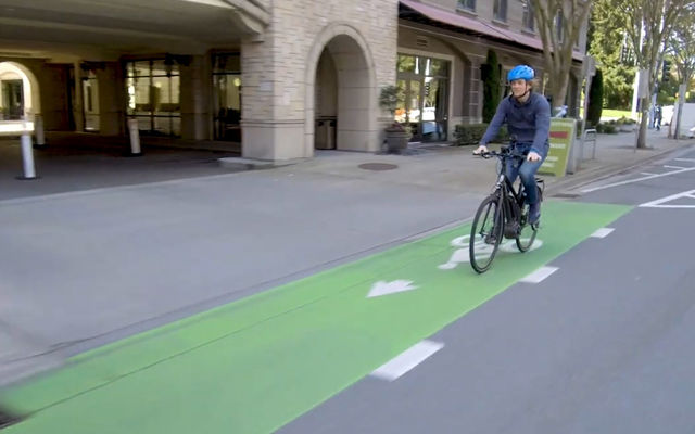 A bicyclist rides the 108th Avenue bikeway downtown.