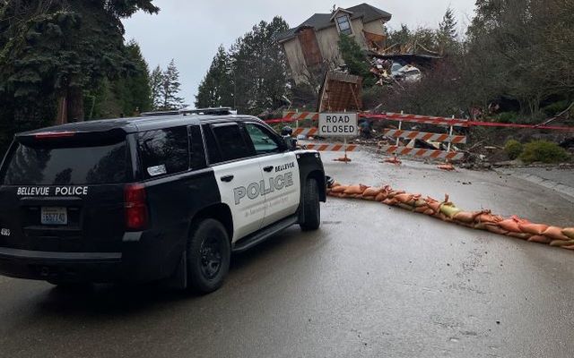 Bellevue police car near area of landslide