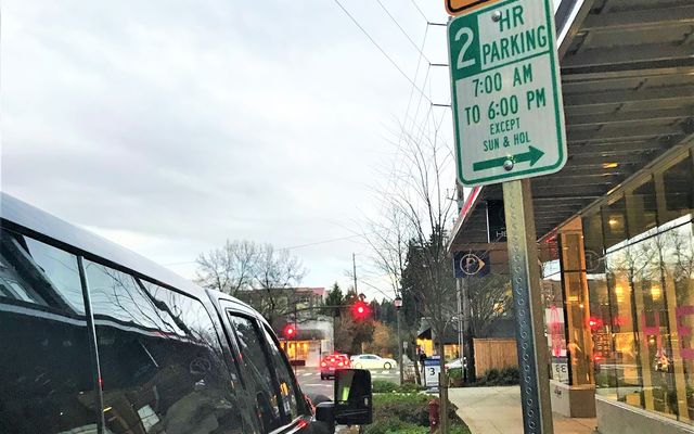 A limousine is parked on a downtown Bellevue street.