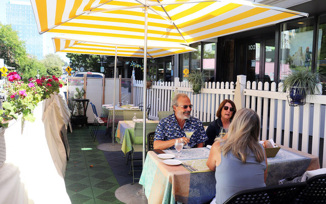 John and Carla Stratfold dine at Bis on Main's al fresco space with their friend Stacy Graven (back to camera).