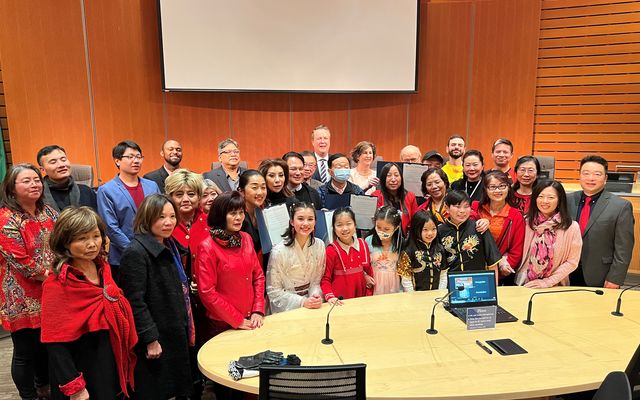 Community members celebrate a proclamation concerning the Lunar New Year.