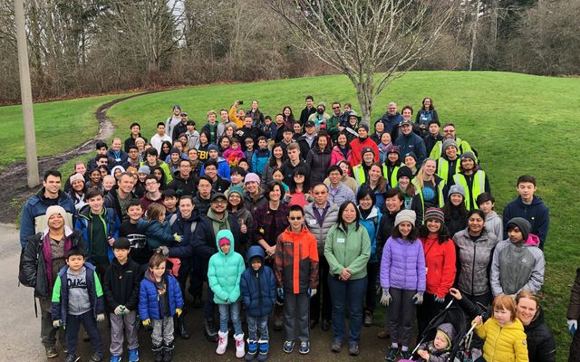 Volunteers pose after a park restoration project.