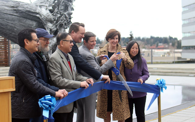 City Council members, City Manager Brad Miyake and Sound Transit CEO Julie Timm clip the ribbon for the reopening of the City Hall plaza.
