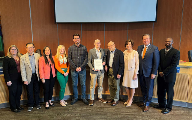 Council members pose with affordable housing week proclamation.