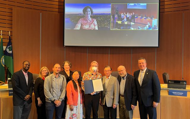 The City Council poses with folks accepting the proclamation for Pride Month.