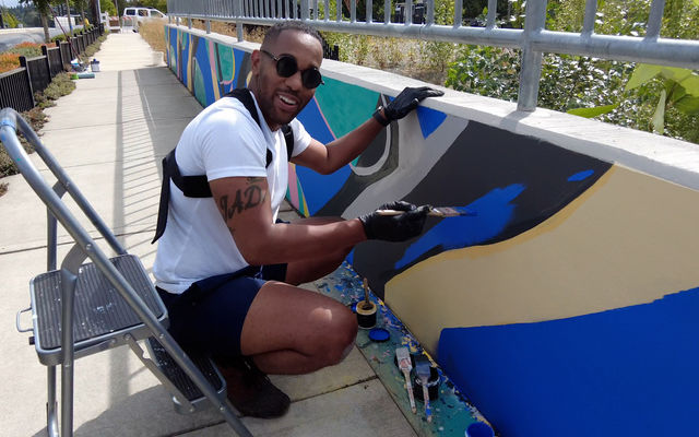 Artist Barry Johnson paints a mural in BelRed.
