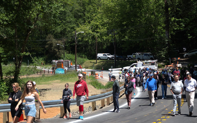 People walk toward the new Lakemont Boulevard bridge before the grand opening.