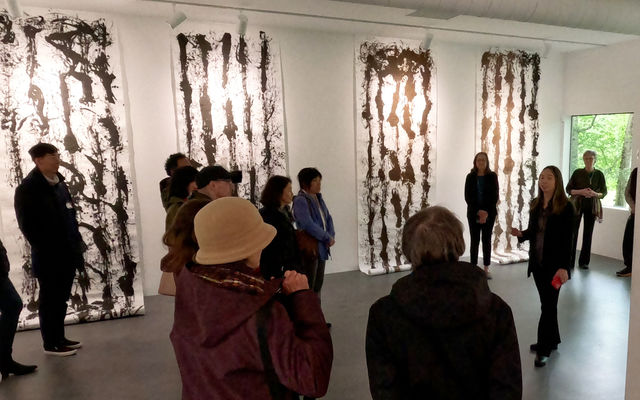 A group of people visit the Yuan Ru Gallery in BelRed.