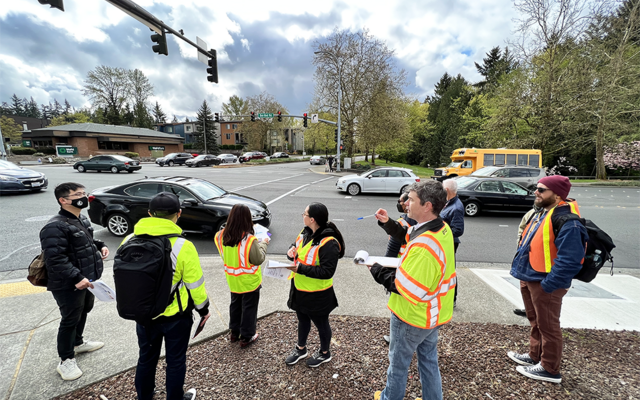 Staff and residents consider potential street design hazards during a road safety assessment.