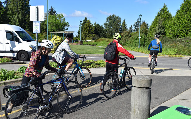 Cyclists ride the 520 trail where it crosses Evergreen Point Road in Medina on Bike Everywhere Day 2024.