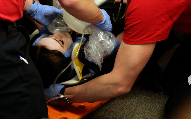 New firefighters demonstrate they know how to perform emergency treatment on another person.