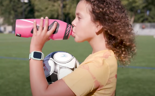 A girl drinks Bellevue water from a water bottle.