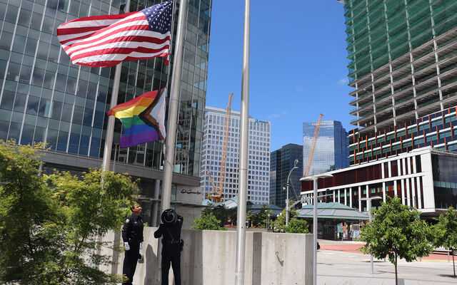 The Honor Guard raises the pride flag at City Hall.