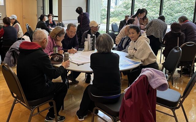 People sit around tables, talking.