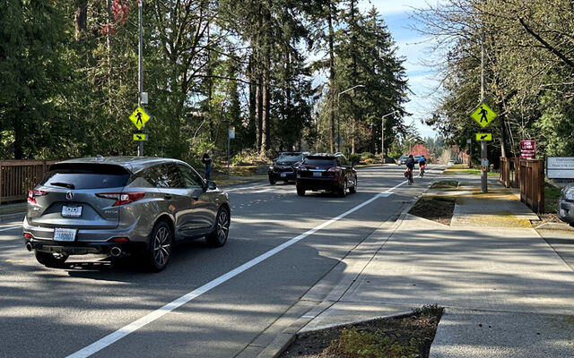 cars travel along a two-lane street