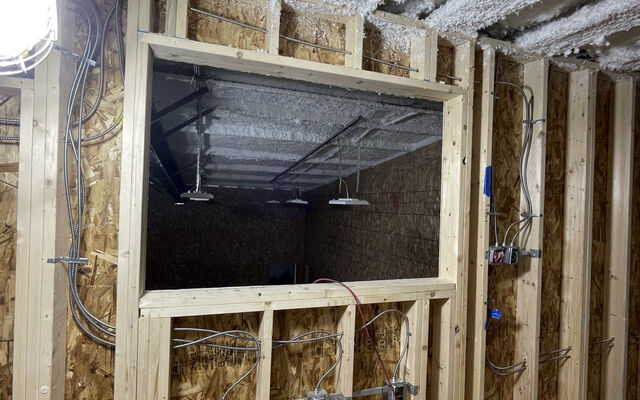 With a city arts grant, Theatre33 undergoes a renovation, with a new wall featuring new wiring and box office.