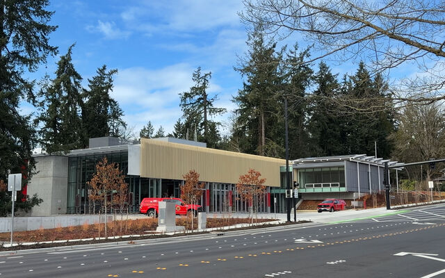 Fire station in front of evergreens