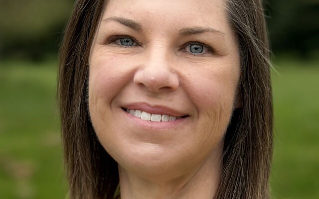 Meredith Petit, standing in a park