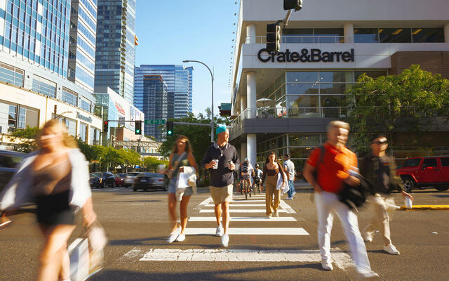 Shoppers walk across Northeast Eighth Street downtown.
