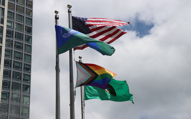The pride flag flies alongside ones for the city, state and country.