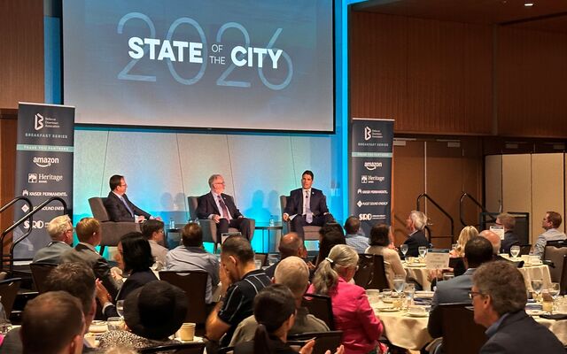 Mayor Mo Malakoutian (right) and Deputy Mayor Dave Hamilton (center) discuss Bellevue while seated on the stage at Meydenbauer Center.