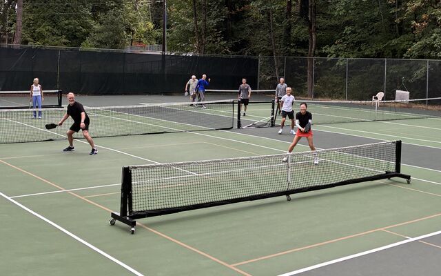 People play pickleball on outdoor pickleball court.