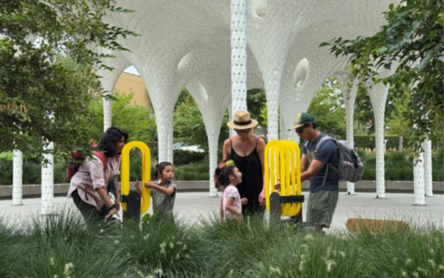 A family plays by the grant-funded Piloti sculpture at Downtown Park.