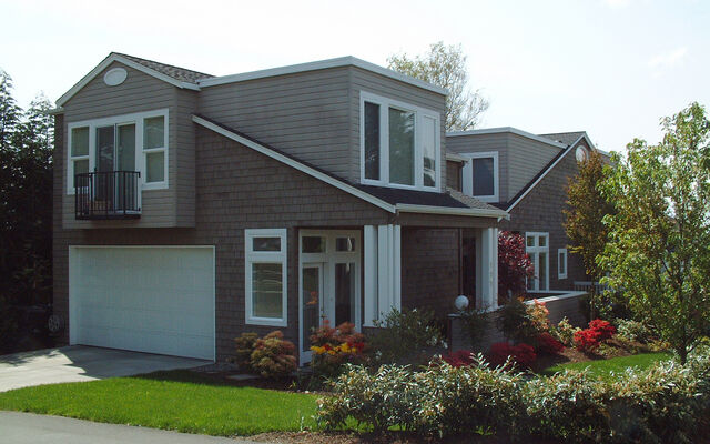 A detached accessory dwelling unit stands on a neighborhood corner.