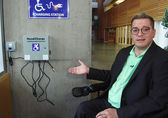 ADA Administrator Blayne Amson shows a wheelchair charging station