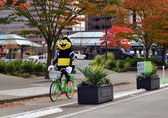 Transportation mascot Pedbee rides a Lime bike on 108th Avenue Northeast.