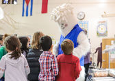 Students gather around the Carbon Yeti, Bellevue's conservation mascot, at the awards ceremony Dec. 12.