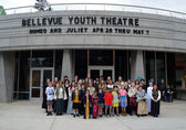 The cast for a Bellevue Youth Theatre stand in front of the theater.