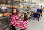 Girls pick up food at the Hopelink food bank.