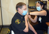 Bellevue Fire Battalion Chief Chuck Heitz receives a vaccine at Overlake Medical Center. Photo courtesy of Overlake