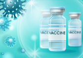 Image of coronavirus with vaccine bottles in the foreground