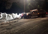 A plow clears the last of the snow on an arterial.