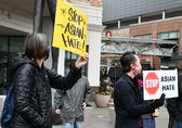 Bellevue residents protest hate crimes against Asian Americans at a rally downtown in March 2021.